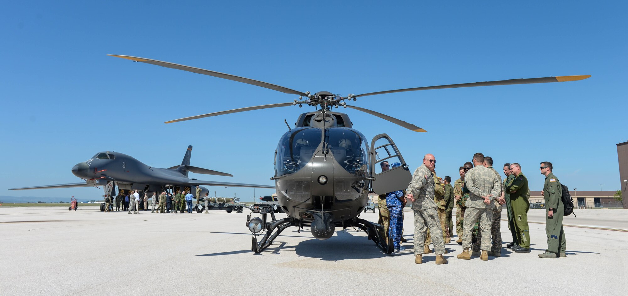 Foreign defense attaché view statics of munitions; a B-1B Lancer, assigned to the 37th Bomb Squadron; and a UH-72 Lakota, which was provided by the South Dakota National Guard, while visiting Ellsworth Air Force Base, S.D., Sept. 4, 2019. Approximately 45 defense attachés from several different countries come to the base to learn more about the mission of the 28th Bomb Wing and the 89th Attack Squadron. (U.S. Air Force photo by Tech. Sgt. Jette Carr)