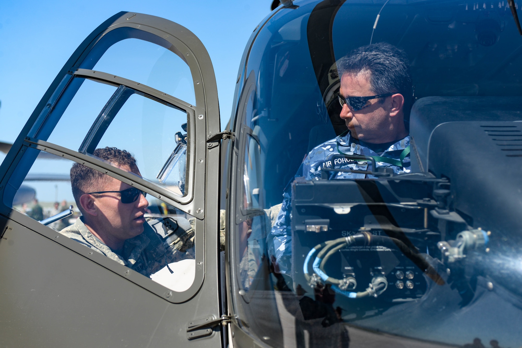 U.S. Army Chief Warrant Officer 2 Rory McCarthy, a pilot assigned to Detachment 1, 1-112th Aviation Regiment, speaks with a foreign defense attaché about the UH-72 Lakota during a tour at Ellsworth Air Force Base, S.D., Sept. 4, 2019. Approximately 45 defense attachés from several different countries visited the base to learn more about the mission of the 28th Bomb Wing and the 89th Attack Squadron.  They toured statics of munitions; a B-1B Lancer, assigned to the 37th Bomb Squadron; and a UH-72, which was provided by the South Dakota National Guard. (U.S. Air Force photo by Tech. Sgt. Jette Carr)