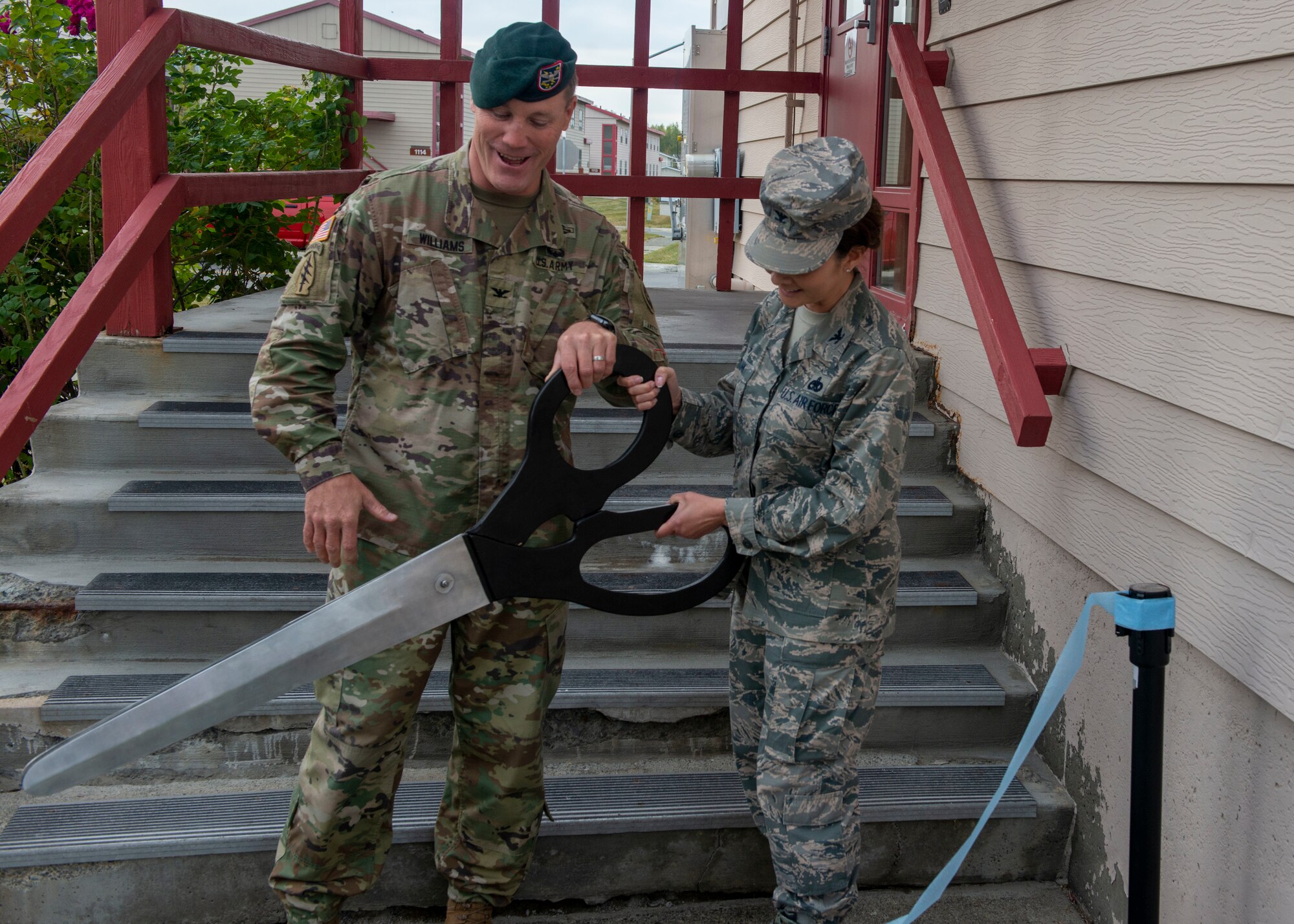 U.S. Army Col. Sean Williams, U.S. Army Alaska chief of staff, and U.S. Air Force Col. Patricia A. Csànk, Joint Base Elmendorf-Richardson and 673d Air Base Wing commander, cut a ribbon during a ceremony held for new distinguished visitors’ quarters on Joint Base Elmendorf-Richardson, Alaska September 6, 2019. The new quarters are the result of a renovation project consisting of demolishing eight visitors’ quarters on the first floor of the Northern Lights Inn and replacing them with four larger business suites for distinguished visitors.