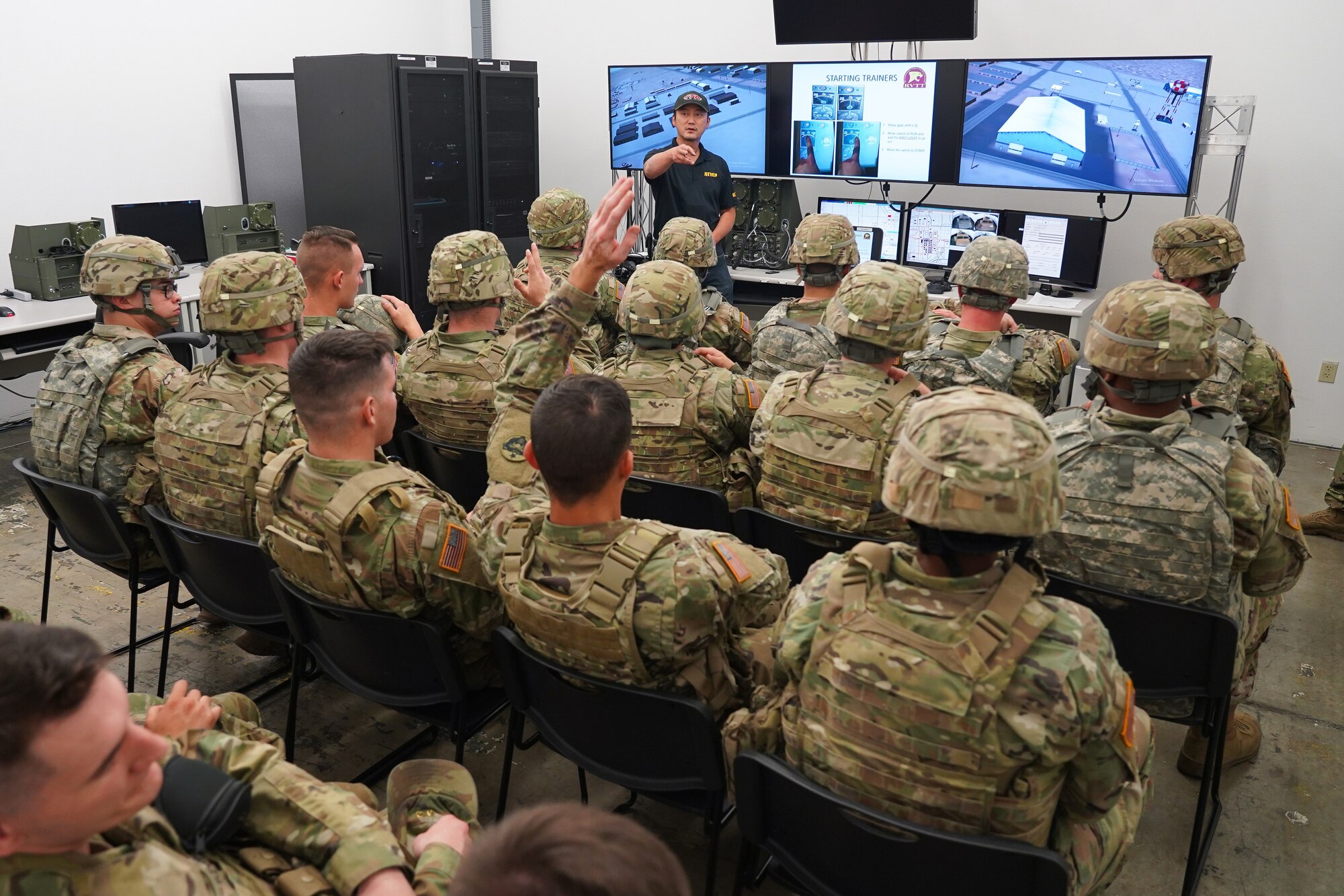 Simulator technician Min Chung gives a briefing to Soldiers assigned to the 98th Support Maintenance Company, 17th Combat Support Sustainment Battalion, U.S. Army Alaska, before they train with the Reconfigurable Vehicle Tactical Trainer on Joint Base Elmendorf-Richardson, Alaska, Sept. 5, 2019. The RVTT provides Soldiers the opportunity to shoot, move, and communicate while mounted in a virtual and controlled environment while taking advantage of customizable exercise scenarios tailored to their unit specific training objectives. (U.S. Air Force photo/Justin Connaher)