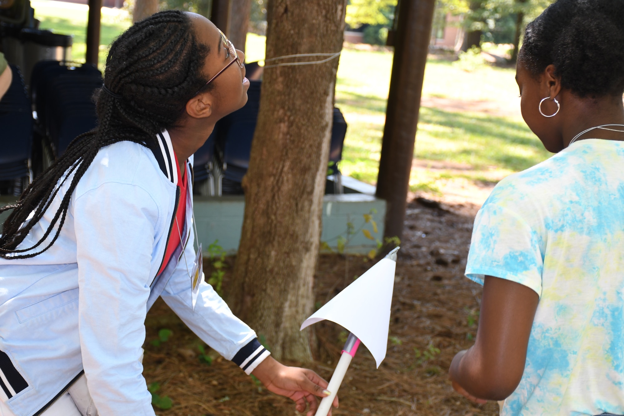 Two middle school female youth attach their rocket to its assembly to test their engineering design at Rock Eagle 4-H Center in Eatonton, Ga., Aug 17, 2019.  The Air Force and space focused programming allowed youth to question and hear from Air Force personnel.    (U.S. Air Force photo by 1st Lt. Casey D. Mull)