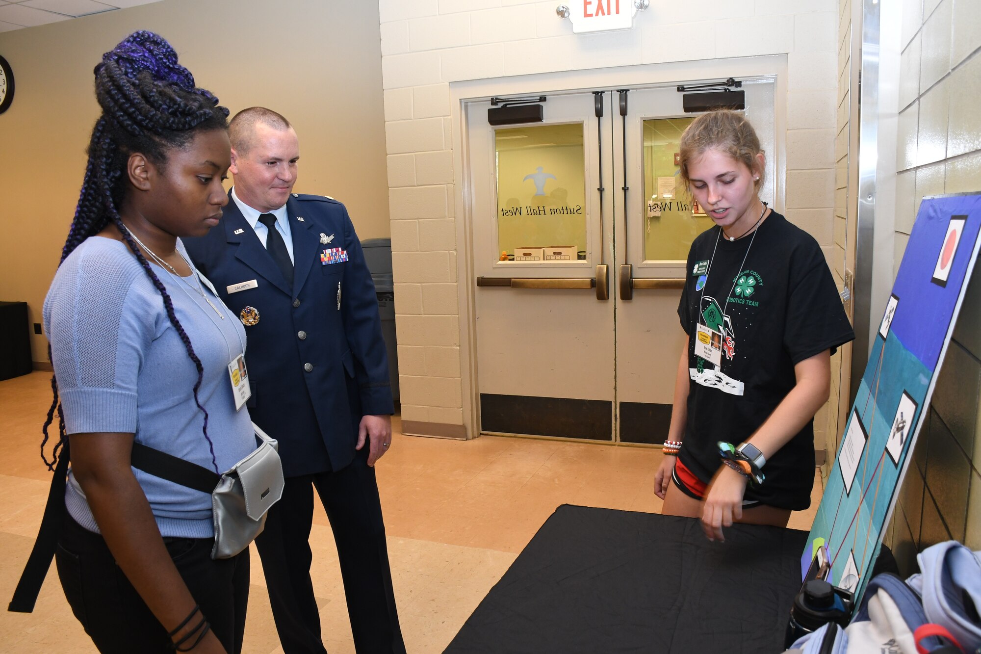 Maj. Benjamin Calhoon, 22nd Air Force executive officer, listens to presentation from Drew Cribbs, high school student from Madison, Ga., about GPS technology at Rock Eagle 4-H Center in Eatonton, Ga., Aug 17, 2019. Maj. Calhoon served as capnote speaker for the event and in previous assignments oversaw operations and policy for GPS.