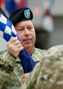 Command Sgt. Maj. John Zimmerman, the incoming command sergeant major, accepts the U.S. Army Reserve’s 99th Readiness Division colors from Maj. Gen. Mark Palzer, the commanding general for the division, signifying he is accepting responsibility for the 99th Readiness Division, during a change of responsibility ceremony Sept. 7, 2019. The change of responsibility is a transition that is rich with symbolism and heritage, and serves the dual function of recognizing the enlisted service of the departing command sergeant major, and providing official recognition of the change of responsibility as senior noncommissioned officer to the incoming command sergeant major. (U.S. Army Reserve Photo by Sgt. Bethany L. Huff)