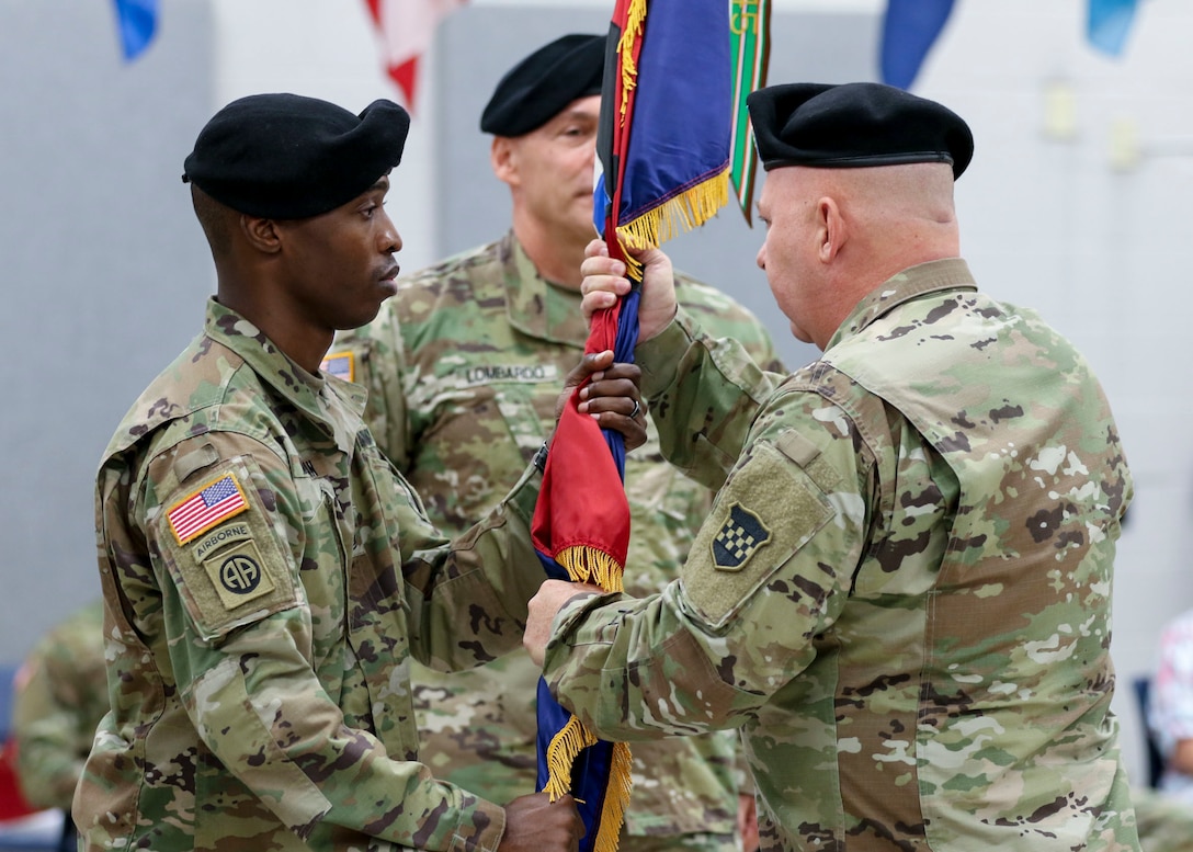 Command Sgt. Maj. Jon Zimmerman, the incoming command sergeant major, passes the U.S. Army Reserve’s 99th Readiness Division colors to 1st Sgt. Earl Morgan, the 99th Readiness Division Headquarters and Headquarters Company first sergeant, during a change of responsibility ceremony Sept. 7, 2019. The change of responsibility is a transition that is rich with symbolism and heritage, and serves the dual function of recognizing the enlisted service of the departing command sergeant major, and providing official recognition of the change of responsibility as senior noncommissioned officer to the incoming command sergeant major. (U.S. Army Reserve Photo by Sgt. Bethany L. Huff)