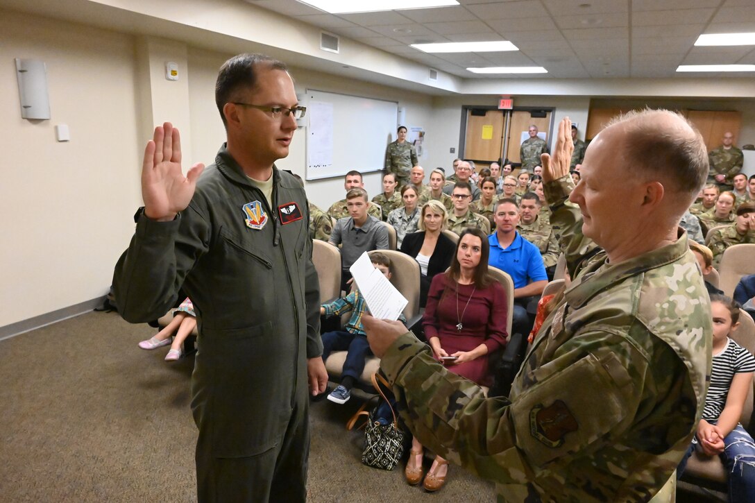 Col. Bryan Delage, the North Dakota National Guard state air surgeon, right, swears in Col. Joseph Wyatt to his promotion rank of colonel as Wyatt assumes the duties of the 119th Medical Group commander at the North Dakota Air National Guard Base, Fargo, N.D., Sept. 7, 2019.