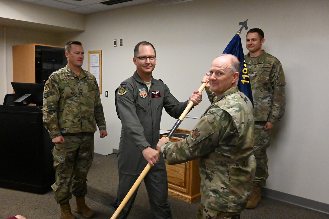 Col. Bryan Delage, the North Dakota National Guard state air surgeon, right, hands the command flag to Col. Joseph Wyatt as Wyatt assumes the duties of the 119th Medical Group commander at the North Dakota Air National Guard Base, Fargo, N.D., Sept. 7, 2019.