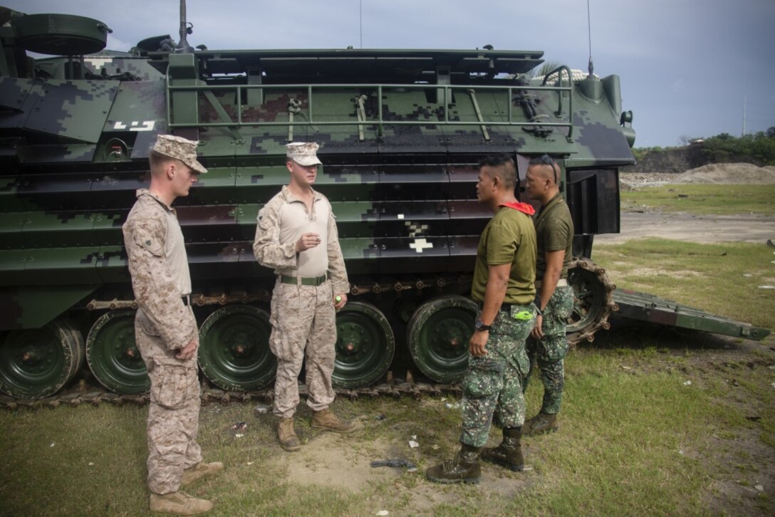 U.S. Marine Corps Sgt. Thomas Pelham and Sgt. Timothy Hoff inspect the tracks of an assault amphibious vehicle with Philippine Marines during an AAV subject matter expert exchange in Subic Bay, Philippines, Aug. 30, 2019. The U.S. Marine Corps has partnered with the Philippine Marine Corps for the last eight years to develop skill sets and policies to enable the Philippine Navy and Marine Corps to conduct amphibious operations. This SMEE was a milestone in these efforts, marking the first time that Philippine forces launched their AAVs from a Philippine Navy amphibious ship and transited from ship to shore. Pelham and Hoff are a mechanic and section leader, respectively, with AAV Company, 4th Marine Regiment, 3rd Marine Division and are natives of Reno, Nev., and Waldorf, Md., respectively. (U.S. Marine Corps photos by Lance Cpl. Jacob Hancock)