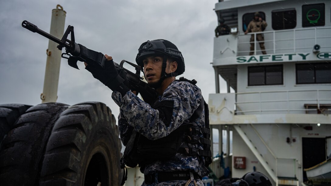 A member of the Philippine Coast Guard holds security during an opposed-boarding drill as part of Baker Piston 19-2, Puerto Princesa, Palawan, Philippines, August 29, 2019. During Baker Piston 19-2, the Marines of the 31st Marine Expeditionary Unit’s Maritime Raid Force are exchanging Visit, Board, Search and Seizure techniques and procedures with members of the Philippine National Police Maritime Group and PCG around the island of Palawan. The 31st MEU, the Marine Corps' only continuously forward-deployed MEU, provides a flexible and lethal force ready to perform a wide range of military operations as the premier crisis response force in the Indo-Pacific region. (Official U.S. Marine Corps photo by Cpl. Isaac Cantrell)