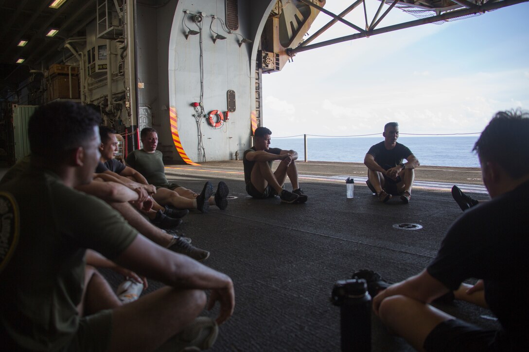 PACIFIC OCEAN (Aug. 8, 2019) Marines and Sailors with the 31st Marine Expeditionary Unit have a guided discussion with Lt. Cmdr Jason Weatherwax, Chaplain with the 31st Marine Expeditionary Unit, after “Chap’s Fit”, a daily workout and discussion group focusing on spiritual toughness, aboard the amphibious assault ship USS Wasp (LHD 1). Wasp, flagship of the Wasp Amphibious Ready Group, with embarked 31st MEU, is operating in the Indo-Pacific region to enhance interoperability with partners and serve as ready-response force for any type of contingency, while simultaneously providing a flexible and lethal crisis response force ready to perform a wide range of military operations. (Official U.S Navy photo by RP3 Anthony Wood-Casella)