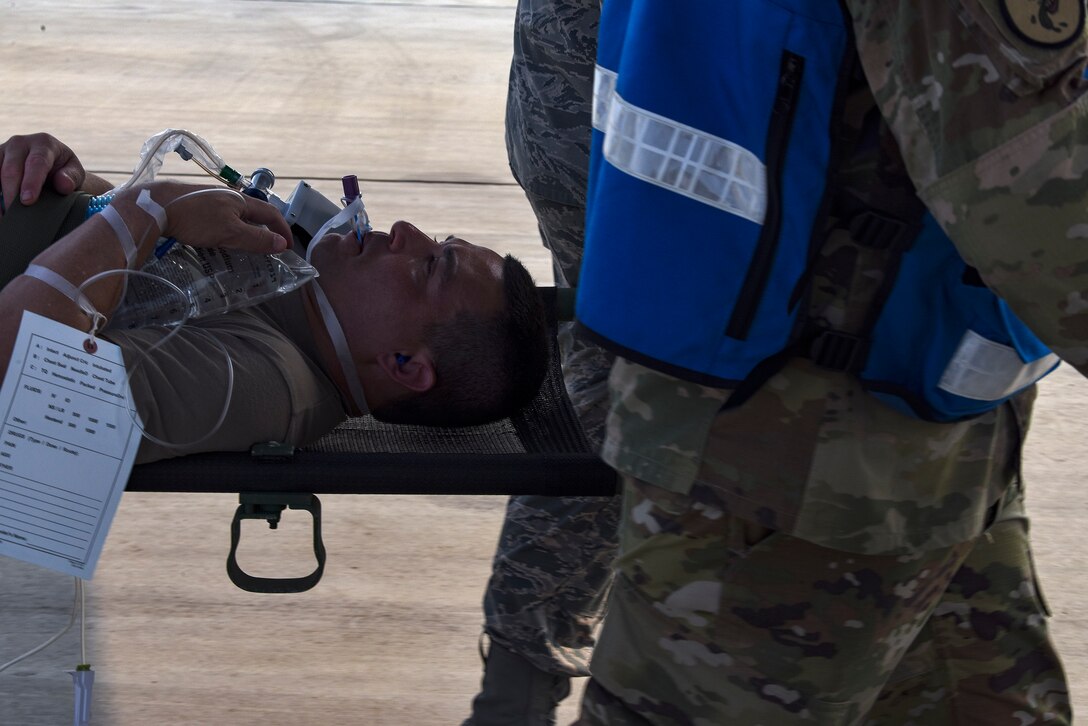 An injured Army patient awaits to be transported onto a C-130J Super Hercules during Operation Ascending Eagle, Aug. 28, 2019, at Osan Air Base, Republic of Korea. Air Force and Army medics jointly operated in the simulated large casualty training to enhance their aeromedical evacuation and patient transportation procedures. (U.S. Air Force photo by Staff Sgt. Greg Nash)