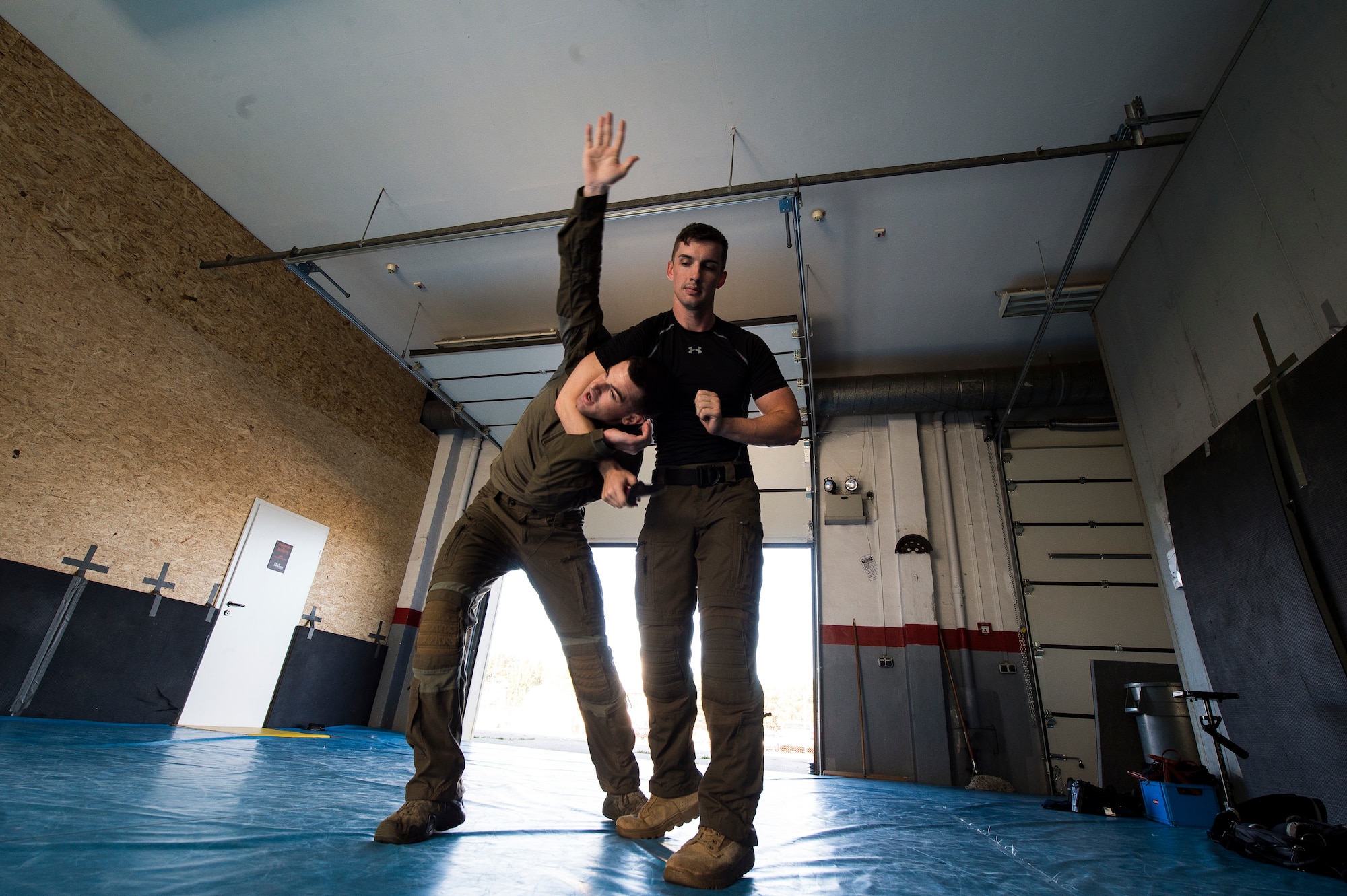 U.S. Air Force 1st Lt. Stephen Cromp, 569th U.S. Forces Police Squadron operations officer and Emergency Services Team leader, demonstrates an escape move against U.S. Air Force Staff Sgt. Brock Miller, 569th USFPS desk sergeant and EST team member, during a counter-knife training at Kapaun Air Station, Germany, Sept. 4, 2019. During the training, Cromp demonstrated a number of counter maneuvers designed to work against an adversary wielding a knife. (U.S. Air Force photo by Staff Sgt. Jonathan Bass)