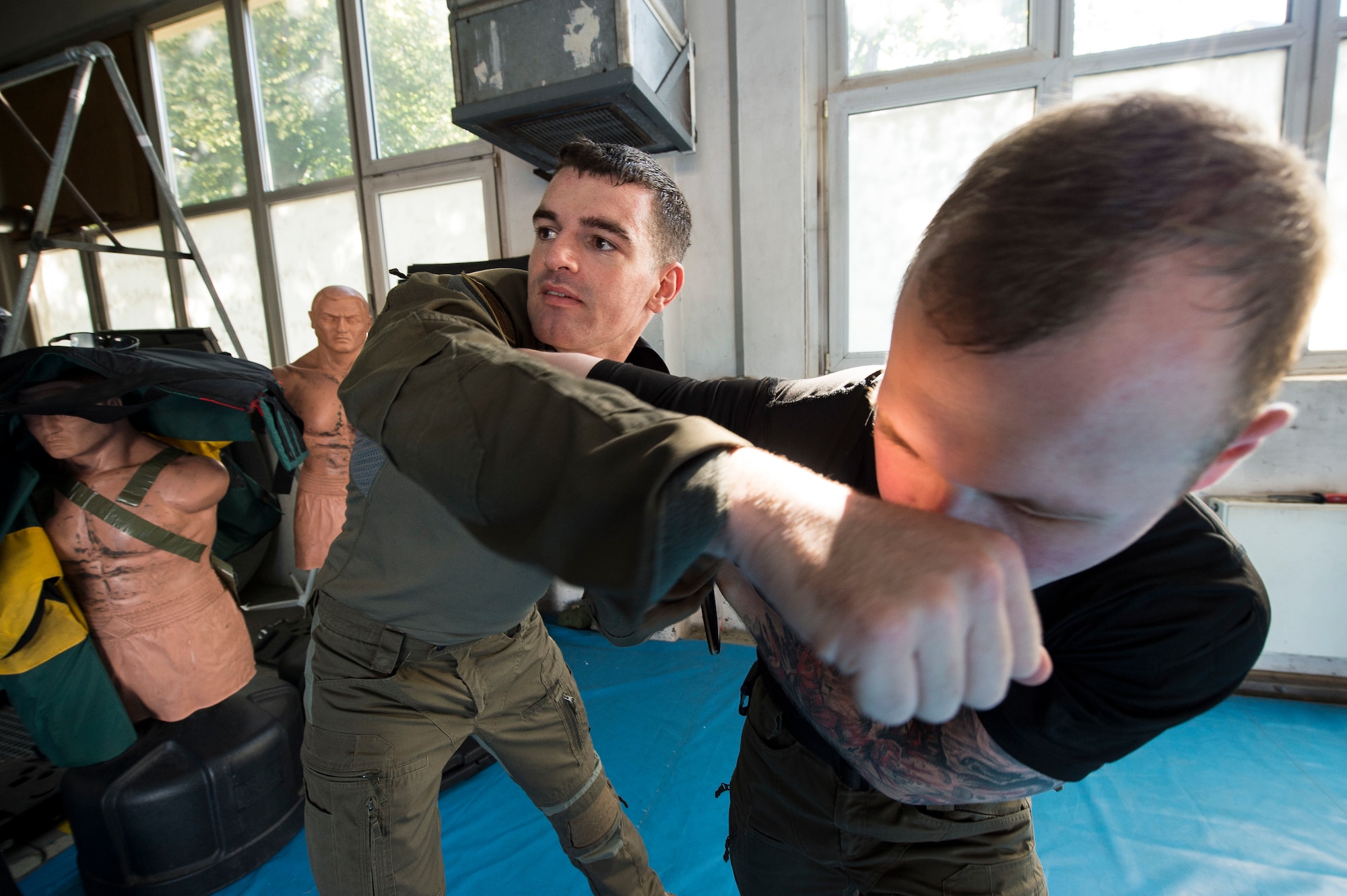 U.S. Air Force 1st Lt. Stephen Cromp, 569th U.S. Forces Police Squadron operations officer and Emergency Services Team leader, demonstrates an escape move against U.S. Air Force Staff Sgt. Robert Harris, 569th USFPS unit training instructor and EST member during a counter-knife training at Kapaun Air Station, Germany, Sept. 4, 2019. Cromp, a Boston, Massachusetts, native, taught a mix of Air Force combatives, common law enforcement takedowns, Krav Maga, and mixed martial arts on each other during the training. (U.S. Air Force photo by Staff Sgt. Jonathan Bass)