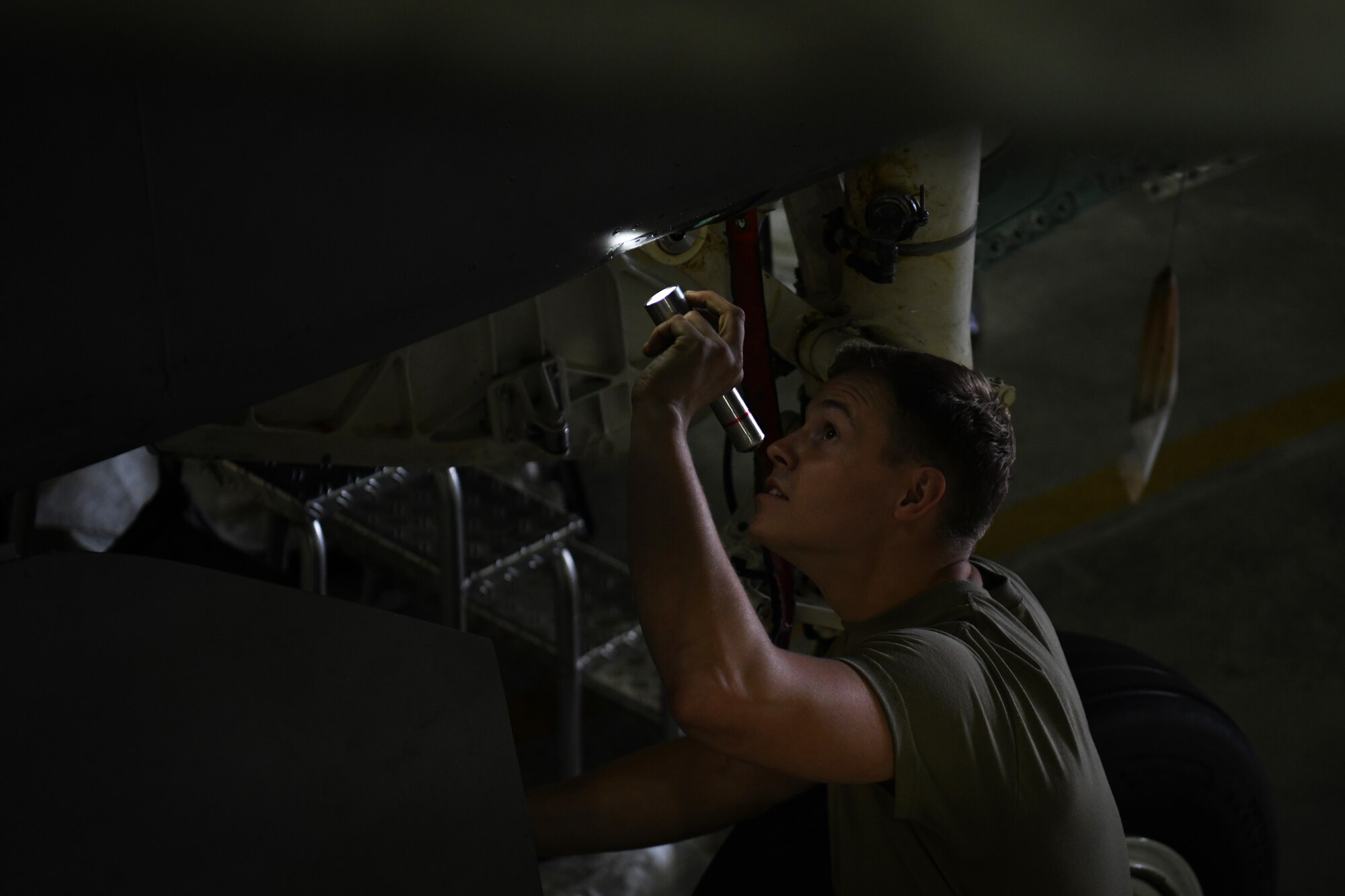 A crew chief assigned to the 48th Equipment Maintenance Squadron inspects an F-15 during a phase inspection at Royal Air Force Lakenheath, England, Aug. 13, 2019. Phase inspections take place every 400 flight hour and focus on structural and systems integrity of the aircraft. (U.S. Air Force photo by Airman 1st Class Shanice Williams-Jones)