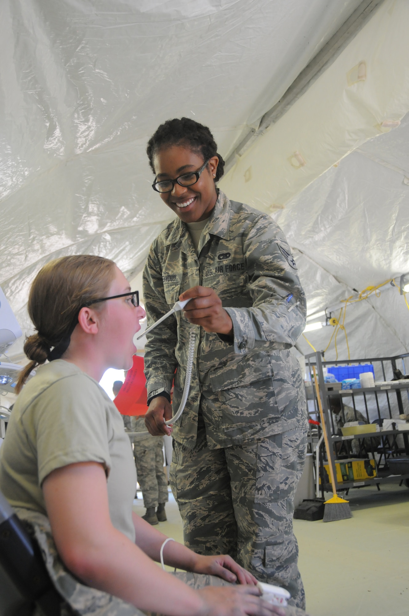 Senior Airman Latrice Greenwood, 445th Aeromedical Staging Squadron aerospace medical technician, checks and records the vital signs of a U.S. Air Force Academy cadet inside the medical triage tent at the Air Force Academy, Colorado Springs, July 23, 2019