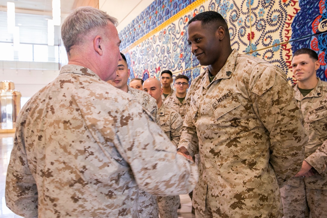 U.S. Marine Corps Gen. Kenneth F. McKenzie, left, the commander of U.S. Central Command, shakes hands with Sgt. Dalen Loftis, a ground radio repairer with the Marine Security Guard Detachment, U.S. Embassy Pakistan, Sept.8, 2019. (U.S. Marine Corps photo by Sgt. Roderick Jacquote)