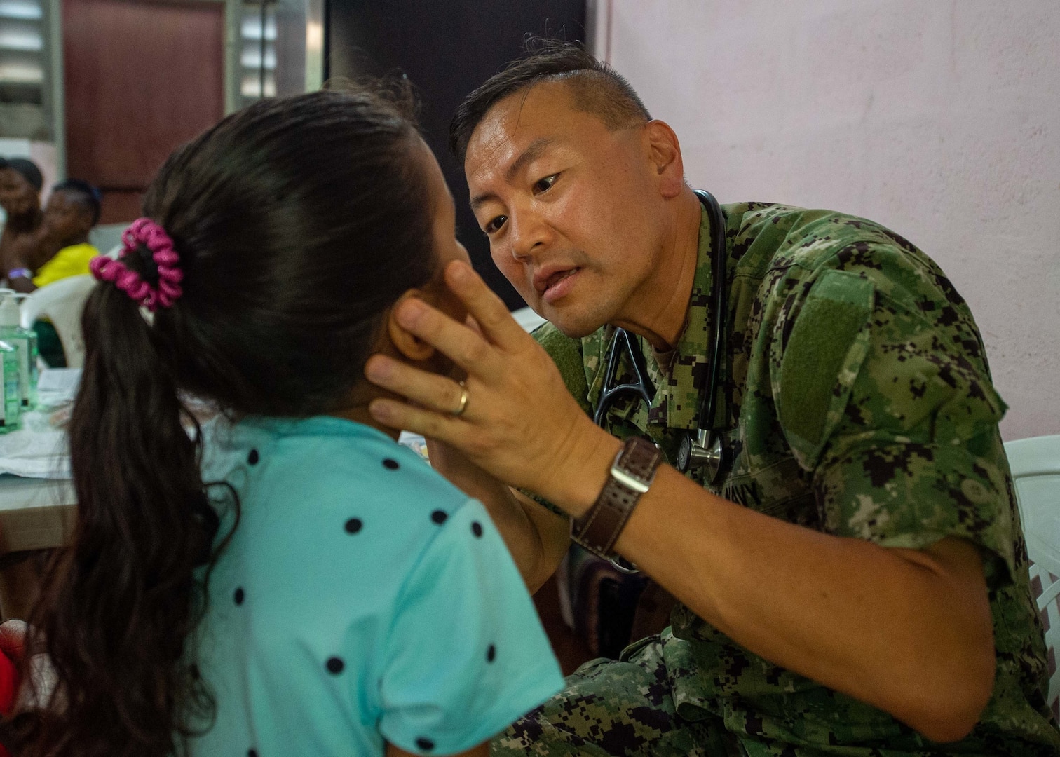 A U.S. Navy doctor examines a child.