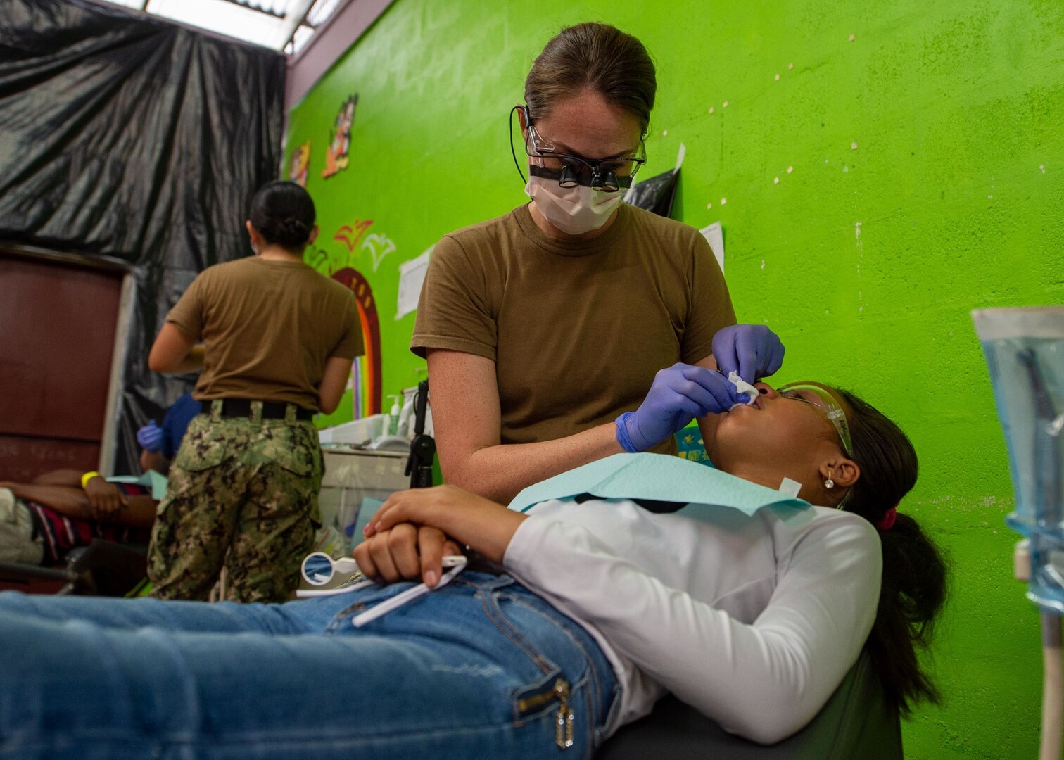 A dentist treats a patient.