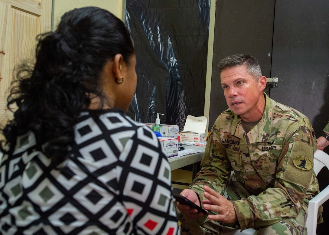 A U.S. Army doctor speaks to a patient.