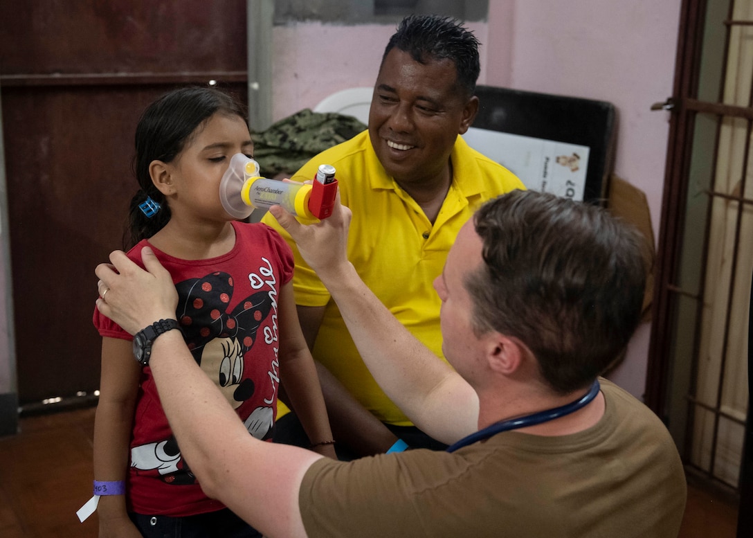 A doctor examines a patient.