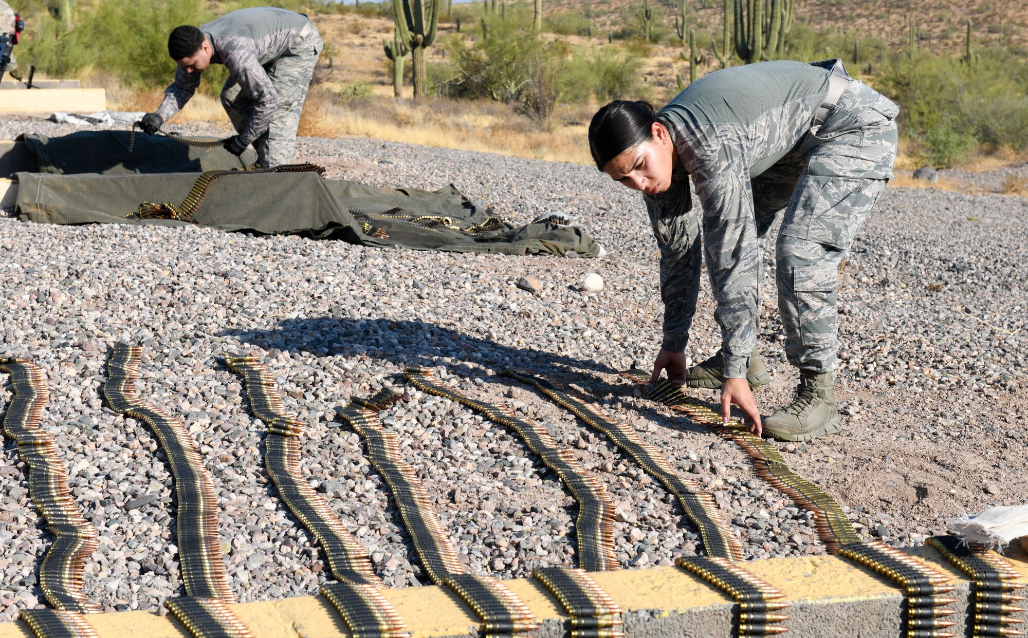 Airman 1st Class Ruth Salgado, 56th Security Forces Squadron installation entry controller, prepares her ammunition for a M249 squad automatic weapon Sept. 4, 2019, at the Arizona Army National Guard range in Florence, Ariz.