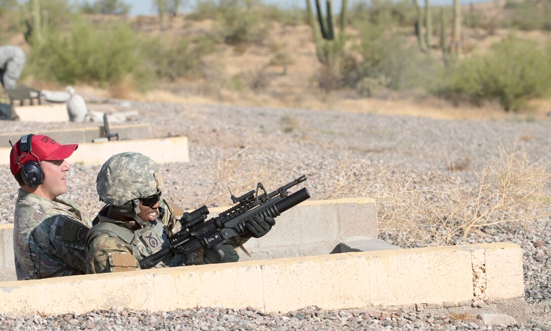 Staff Sgt. Treveyon Young, 56th Security Forces Squadron flight sergeant, fires a round from his M203 grenade launcher Sept. 4, 2019, at the Arizona Army National Guard range in Florence, Ariz.