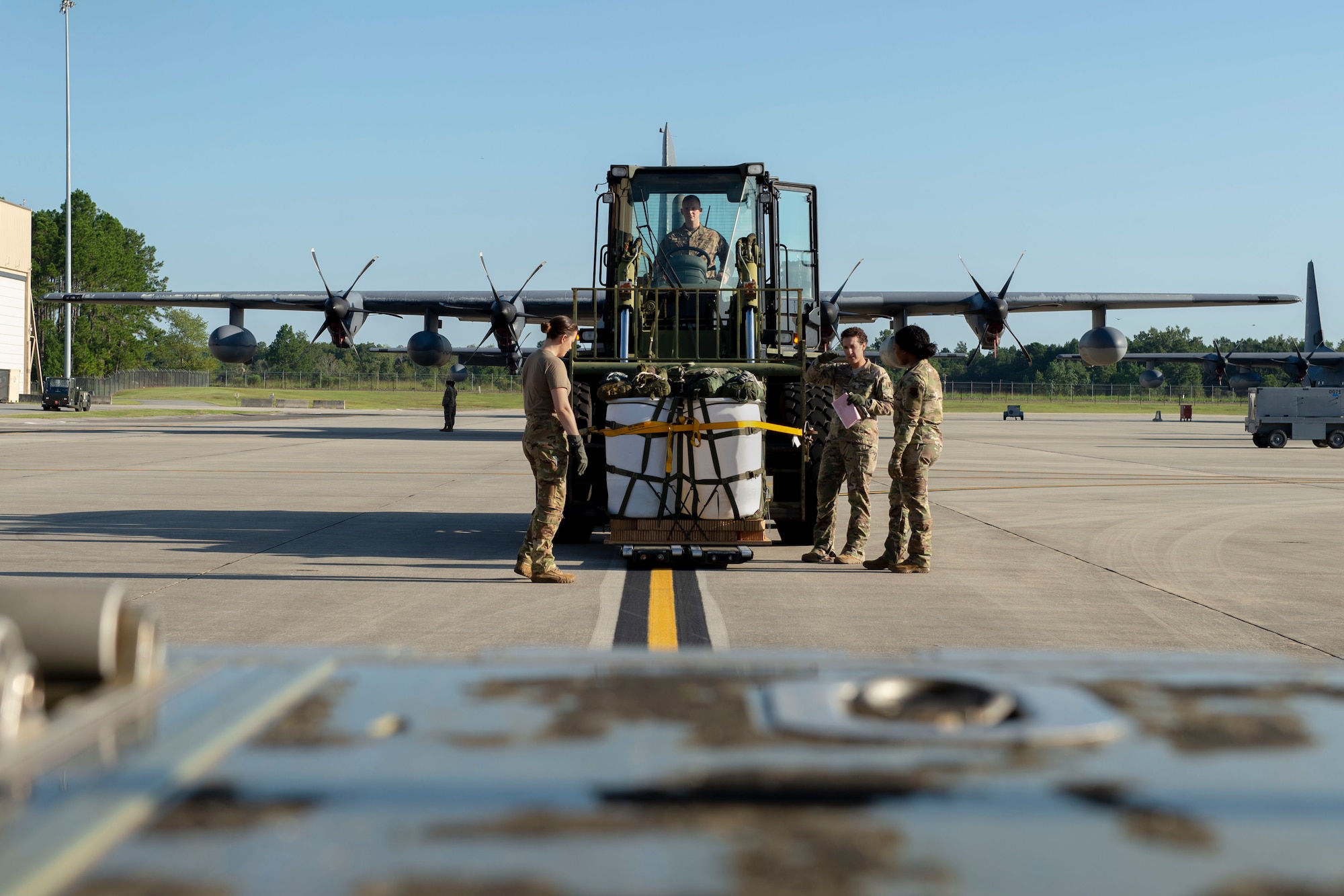 71st Rescue Squadron (RQS) loadmasters prepare to load a container delivery system on to the ramp of an HC-130J Combat King II before conducting the airframe’s first flight to be operated by an all-female aircrew Sept. 6, 2019, at Moody Air Force Base, Ga. The 71st RQS provides rapidly deployable, expeditionary personnel recovery forces for contingency and crisis response operations worldwide. (U.S. Air Force photo by 2nd Lt. Kaylin P. Hankerson)