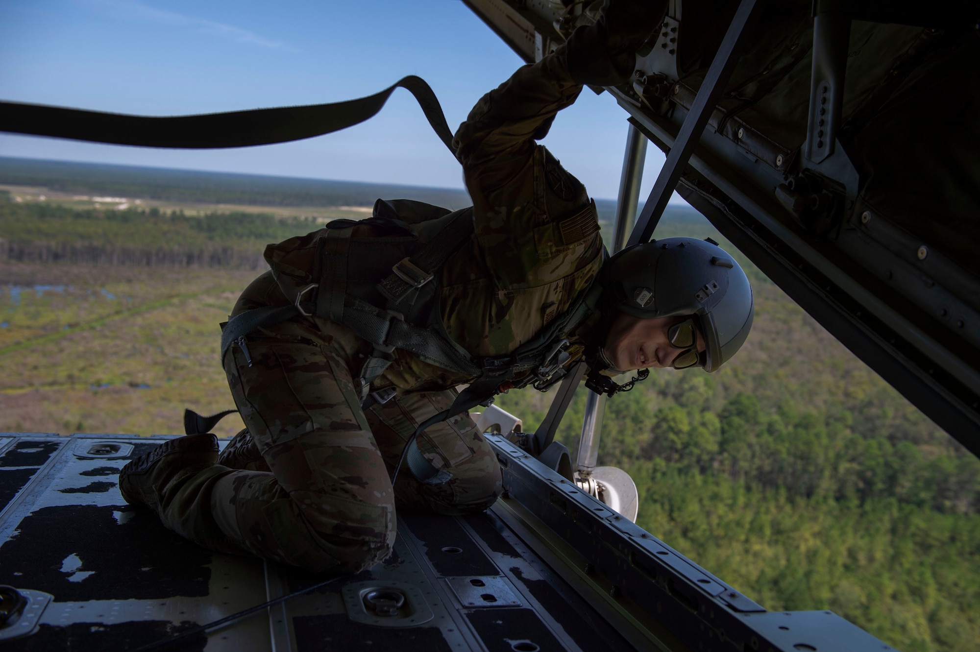 Tech. Sgt. Colleen McGahuey-Ramsey, 71st Rescue Squadron (RQS) loadmaster, visually confirms the target for a loadmaster directed rescue drop Sept. 6, 2019, at Moody Air Force Base, Ga. This was the first flight for the 71st RQS and the HC-130J Combat King II airframe to be operated by an all-female aircrew. The 71st RQS provides rapidly deployable, expeditionary personnel recovery forces for theater commanders for contingency and crisis response operations worldwide. (U.S. Air Force photo by 2nd Lt. Kaylin P. Hankerson)