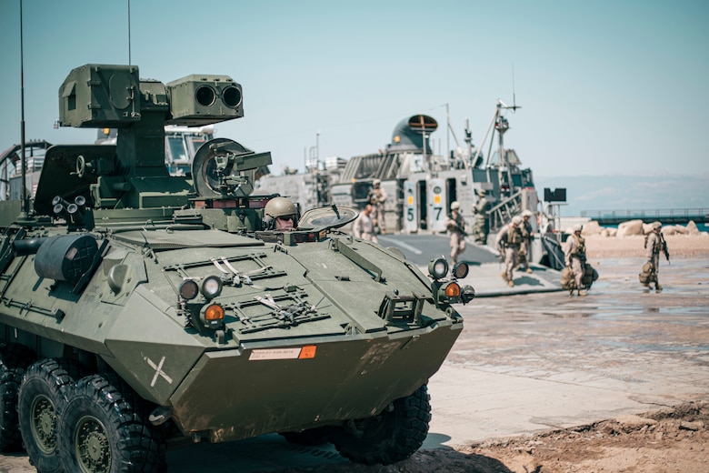 A U.S. Marine drives a light armored vehicle off of a landing craft, air cushion after coming ashore at Aqaba, Jordan, in support of exercise Eager Lion 2019, Aug. 31.