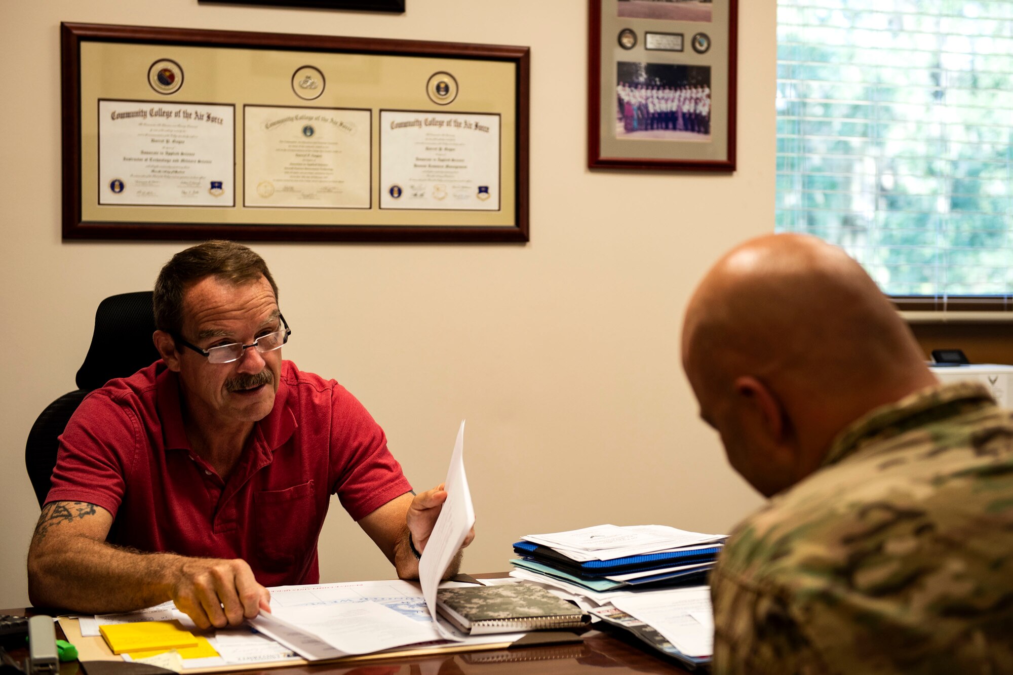Darryl Gagne, left, 23d Force Support Squadron education specialist, gives advice to Master Sgt. Andrew Blackwell, 23d Civil Engineer Squadron section chief of commander’s support staff, Sept. 5, 2019, at Moody Air Force Base, Ga. The education center at the Information Learning Center equips Airmen with the tools they need to further their education, be it finishing their Community College of the Air Force degree or continuing higher education. (U.S. Air Force photo by Senior Airman Erick Requadt)