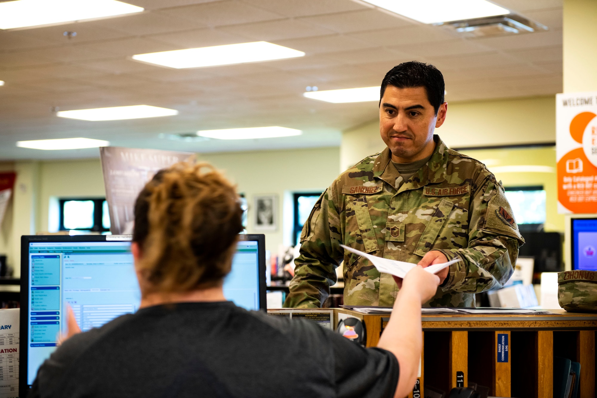 Master Sgt. Brian Sanchez, right, 23d Medical Support Squadron laboratory and diagnostic imaging flight chief, gets assistance from Katrina True, 23d Force Support Squadron library aid, Sept. 5, 2019, at Moody Air Force Base, Ga. The Information Learning Center serves as the central hub for all informational and educational growth for Airmen and their families here. (U.S. Air Force photo by Senior Airman Erick Requadt)