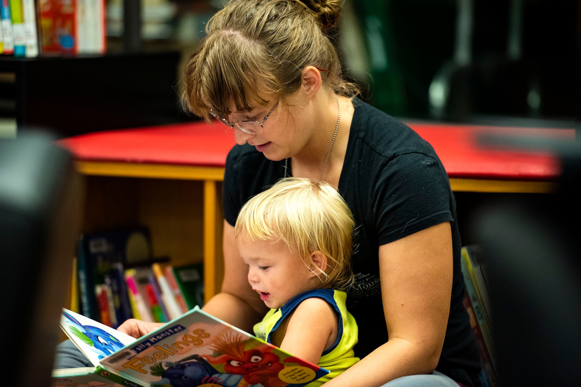 Megan Thorne, military spouse, reads to her son, Layton, Sept. 5, 2019, at Moody Air Force Base, Ga. The Information Learning Center provides a means of morale and serves as the central hub for all informational and educational growth for Airmen and families. (U.S. Air Force photo by Senior Airman Erick Requadt)