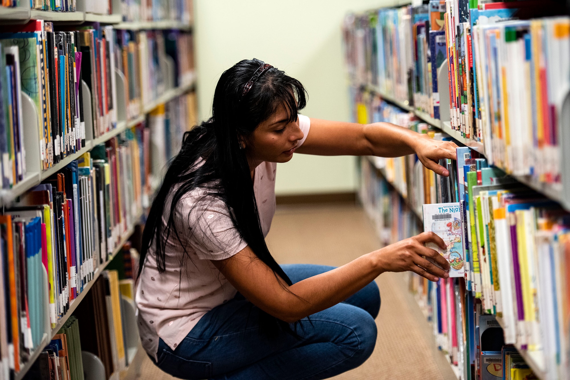 Yoselin Kilpatrick, 23d Force Support Squadron library aid, returns a book Sept. 5, 2019, at Moody Air Force Base, Ga. With more than 10k books available at the library, it’s just one of the many benefits at the Information Learning Center available to Airmen and families. (U.S. Air Force photo by Senior Airman Erick Requadt)