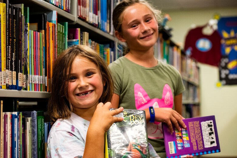 Zophia, front, and Athena, daughters of Lindsay Clark, military spouse, pose for a photo Sept. 5, 2019, at Moody Air Force Base, Ga. The Information Learning Center provides a means of morale and serves as the central hub for all informational and educational growth for Airmen and families. (U.S. Air Force photo by Senior Airman Erick Requadt)