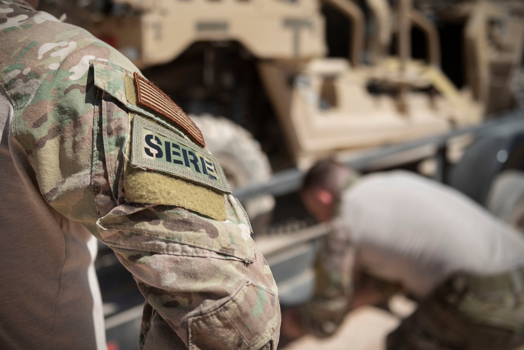 A survival, evasion, resistance, and escape (SERE) specialist assigned to the 414th Combat training Squadron, watches as another SERE specialist straps down heavy equipment on the Nevada Test and Training Range (NTTR), August 29, 2019