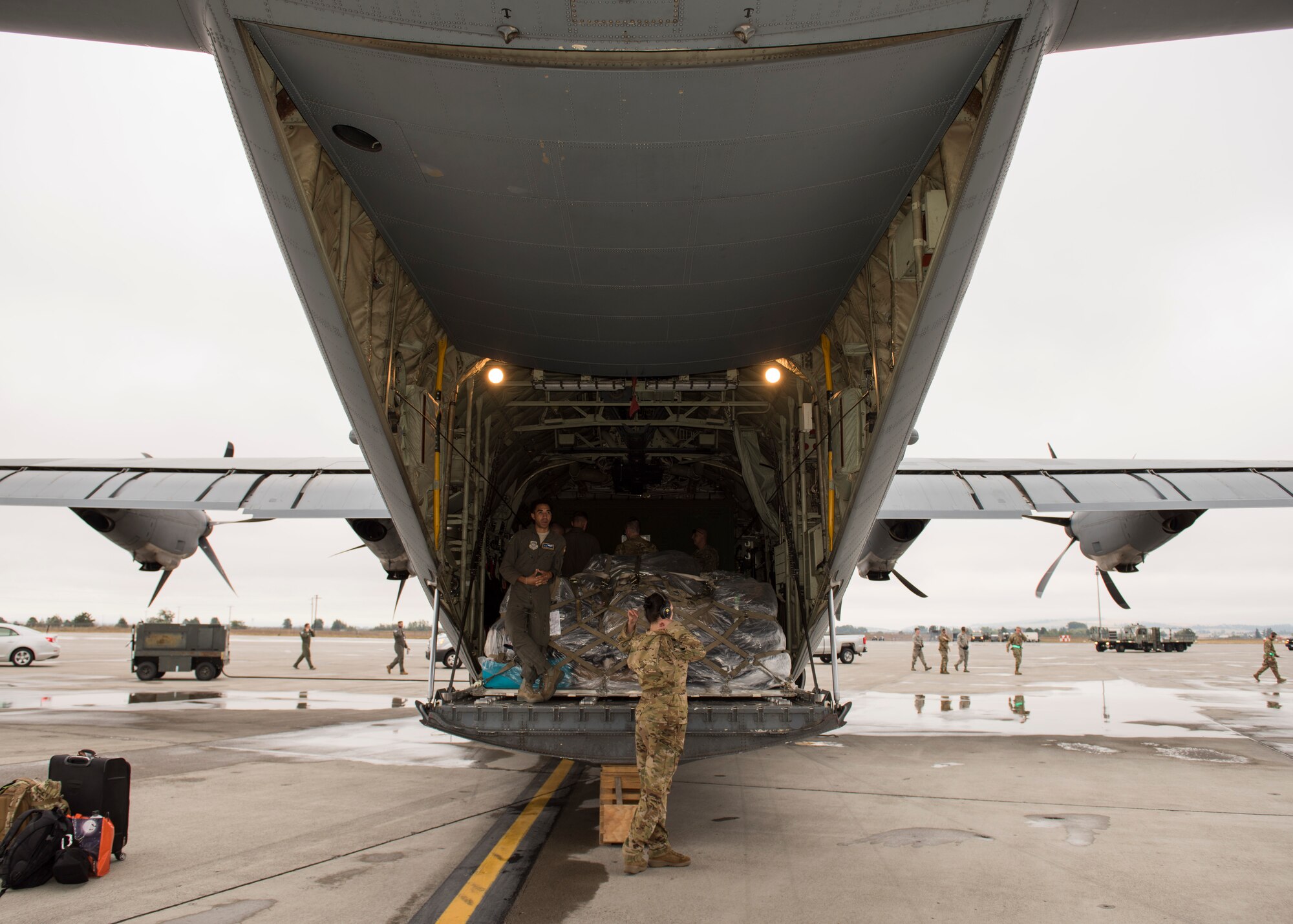A C-130 Hercules crew from Little Rock Air Force Base, Arkansas, prepares to unload cargo at the start of Air Mobility Command’s Mobility Guardian 2019 exercise at Fairchild Air Force Base, Washington, Sept. 8, 2019. Through robust and relevant training, Mobility Guardian is designed to build full spectrum readiness and develop Air Mobility Airmen to ensure we deliver rapid global mobility now and in the future. (U.S. Air Force photo by Senior Airman Ryan Lackey)