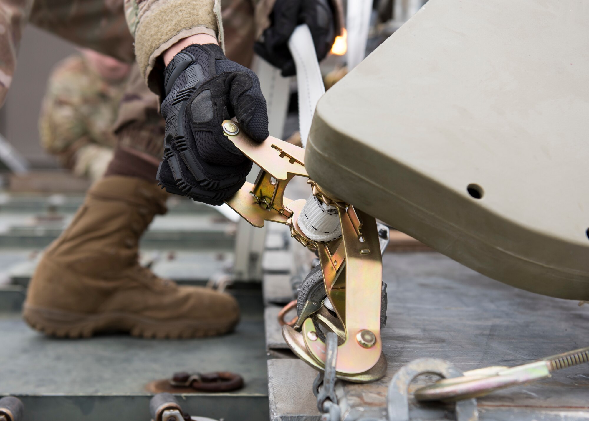 Senior Airman Michael Holland, 43rd Air Mobility Operations Group aircraft services team chief, tightens a strap during a cargo movement on the first day of Air Mobility Command’s Mobility Guardian 2019 exercise at Fairchild Air Force Base, Washington, Sept. 8, 2019. Through robust and relevant training, Mobility Guardian is designed to build full spectrum readiness and develop Mobility Airmen to deliver rapid global mobility now and in the future. (U.S. Air Force photo by Senior Airman Ryan Lackey)