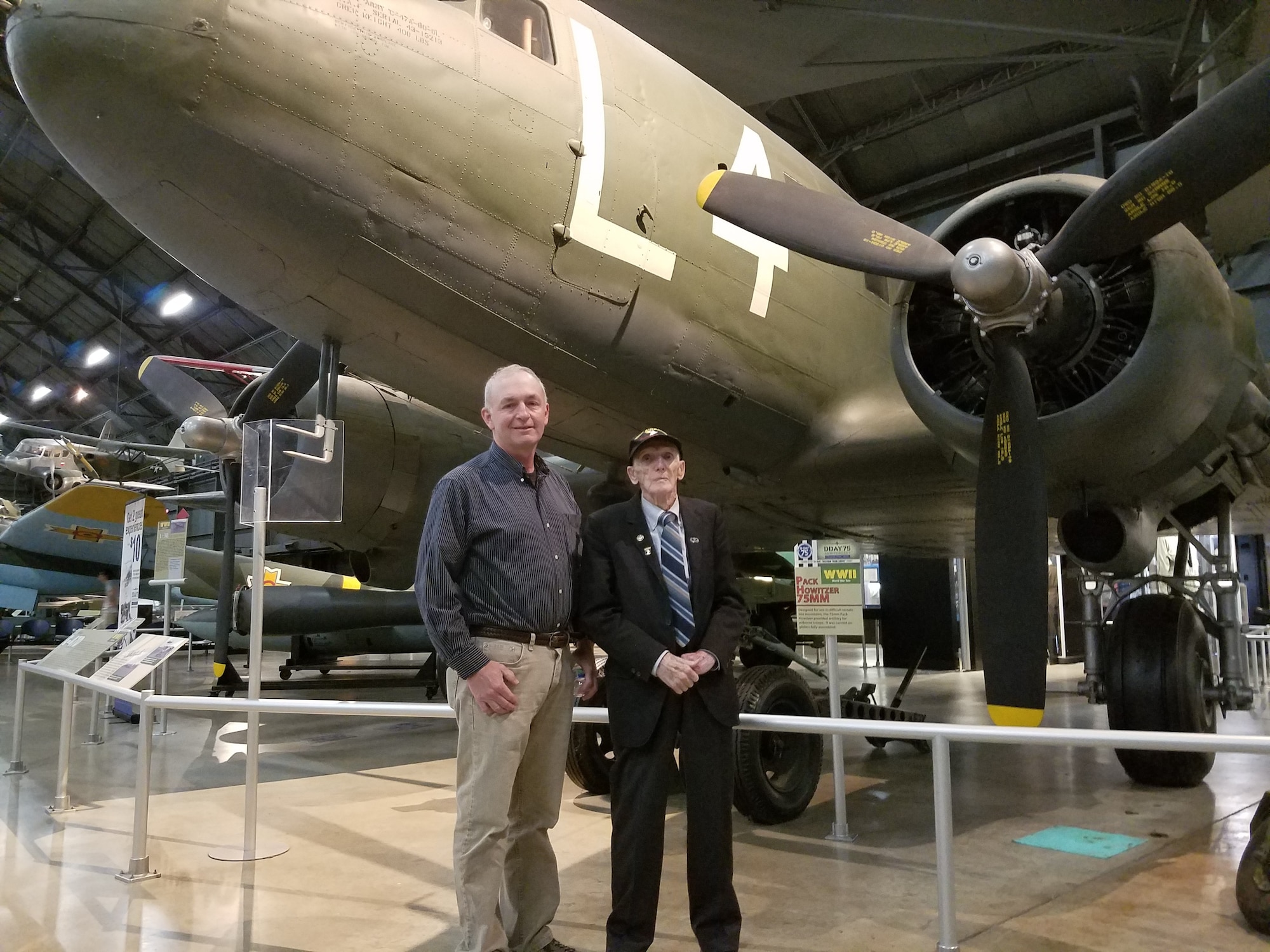 Air Force Research Laboratory Aerospace Systems Directorate employee Kevin Price (left) and World War II veteran Jim “Pee Wee” Martin look over the C-47 aircraft displayed at the National Museum of the United States Air Force on August 30, 2019. Price will accompany the 98-year-old Martin in September as he travels to the Netherlands to parachute into the region he helped liberate 75 years ago as part of Operation Market Garden. (U.S. Air Force Photo/Holly Jordan)