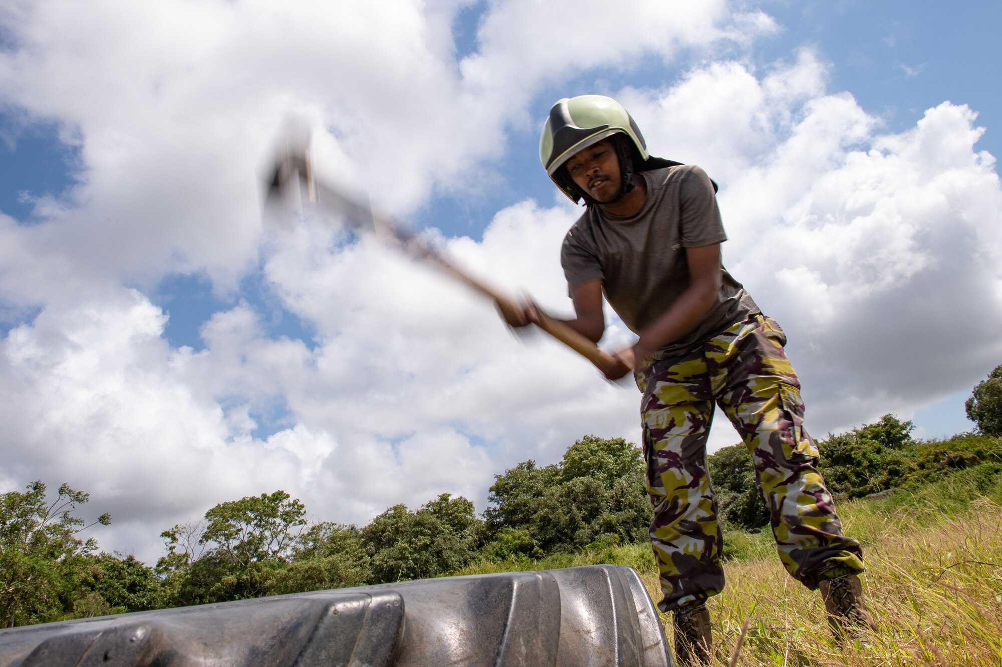 A Kenya Navy firefighter swings a hammer during a training circuit at Manda Bay, Kenya, Aug. 29, 2019. The training, held by 475th Expeditionary Air Base Squadron firefighters, was designed to build upon the established partnership between the two nations by enforcing teamwork and endurance while enhancing technical proficiency. (U.S. Air Force photo by Staff Sgt. Devin Boyer)