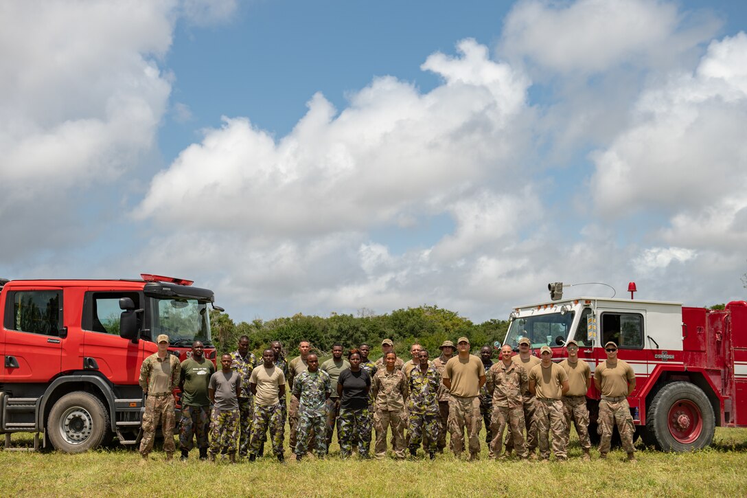 U.S. Air Force firefighters assigned to the 475th Expeditionary Air Base Squadron, and Kenya Navy firefighters pose for a group photo at Manda Bay, Kenya, Aug. 29, 2019. The 475th EABS firefighters hosted training designed to build upon the established partnership between the two nations by enforcing teamwork and endurance while enhancing technical proficiency. (U.S. Air Force photo by Staff Sgt. Devin Boyer)
