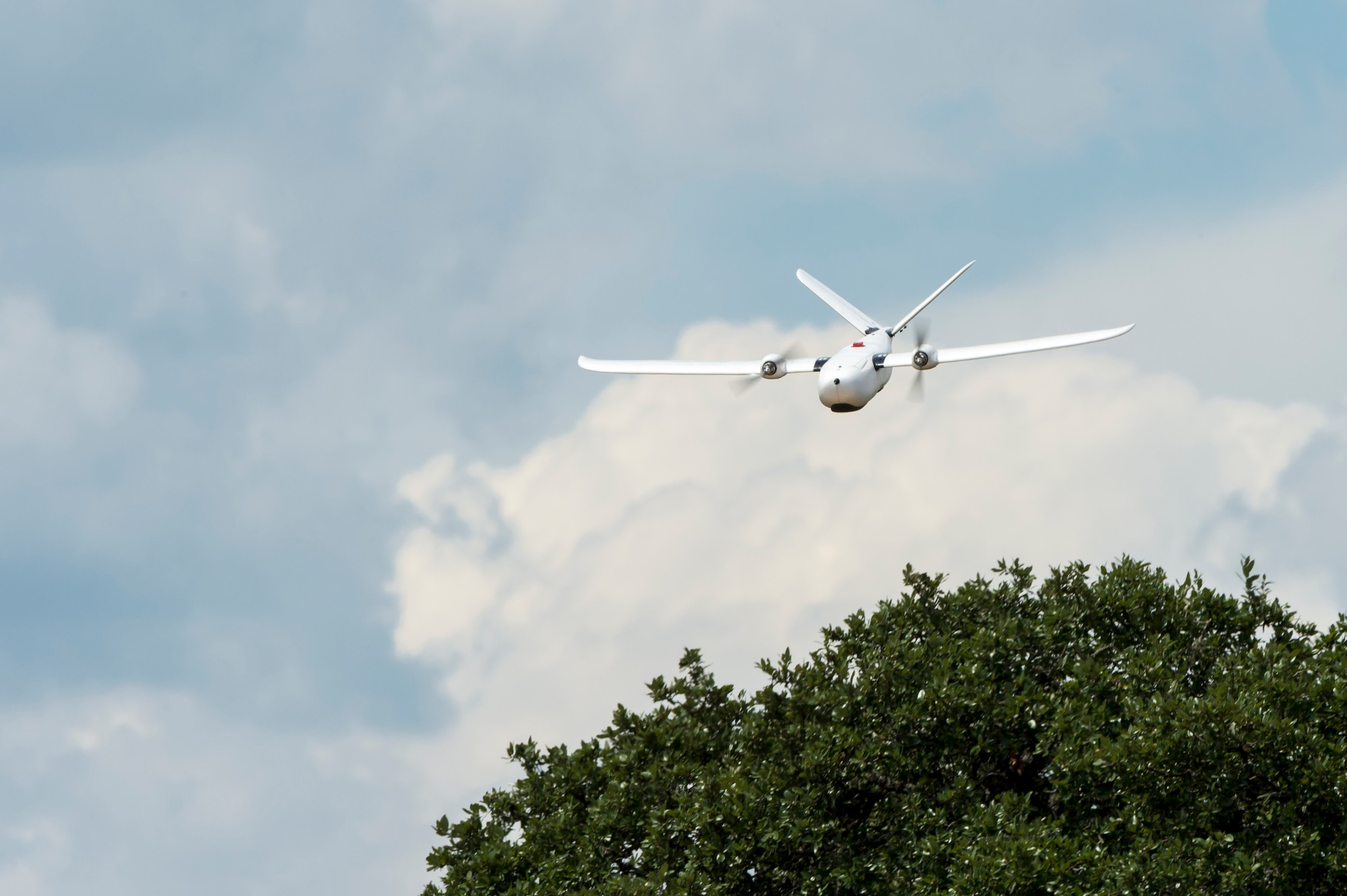 An unmanned aerial system flies over Camp Bullis, Texas, during a field test Sept. 4. The UAS was equipped with Light Detection and Ranging, multi-spectral sensors and machine-learning algorithms to map, survey and inventory habitat for the golden-cheeked warbler. The field test will help the Air Force determine if UAS technology can characterize habitat better, faster and cheaper than current methods.