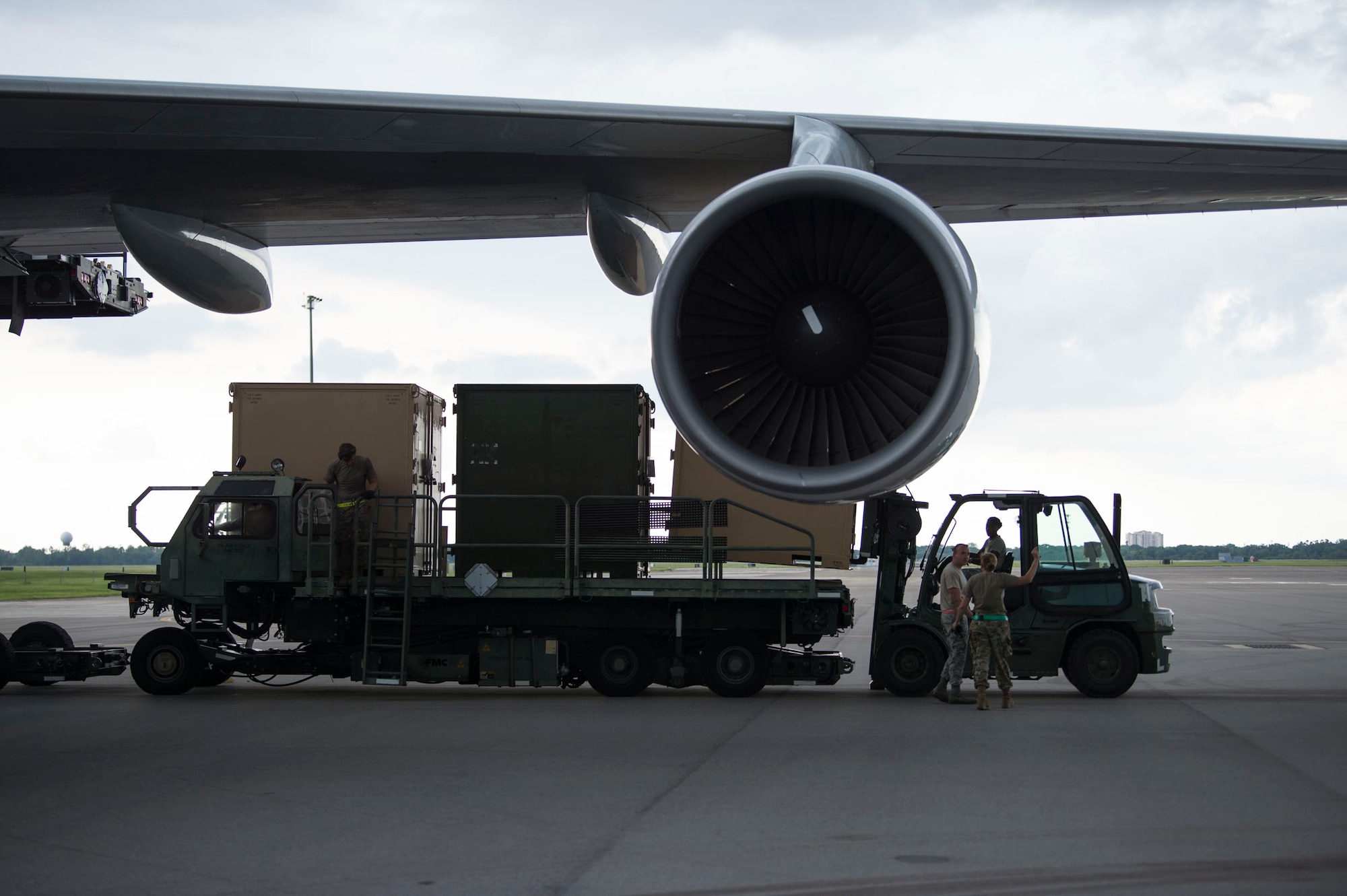 Members of the 6th Logistics Readiness Squadron (LRS) remove cargo from a Boeing 747 aircraft during a cargo movement at MacDill Air Force Base, Fla., July 31, 2019. With 32 increments of cargo weighing 144,470 pounds, this movement equates to 22 percent of total tonnage moved by the 6th LRS in 2019. The cargo belonged to the Joint Communications Support Element. (U.S. Air Force photo by Senior Airman Adam R. Shanks)