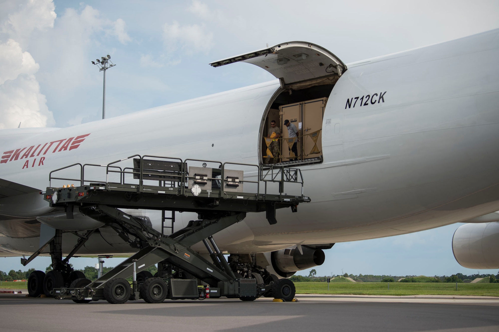 Members of the 6th Logistics Readiness Squadron position a cargo loader next to a Boeing 747 aircraft during a cargo movement at MacDill Air Force Base, Fla., July 31, 2019. The cargo belonged to the Joint Communications Support Element and contained equipment that has been deployed since 2012. (U.S. Air Force photo by Senior Airman Adam R. Shanks)