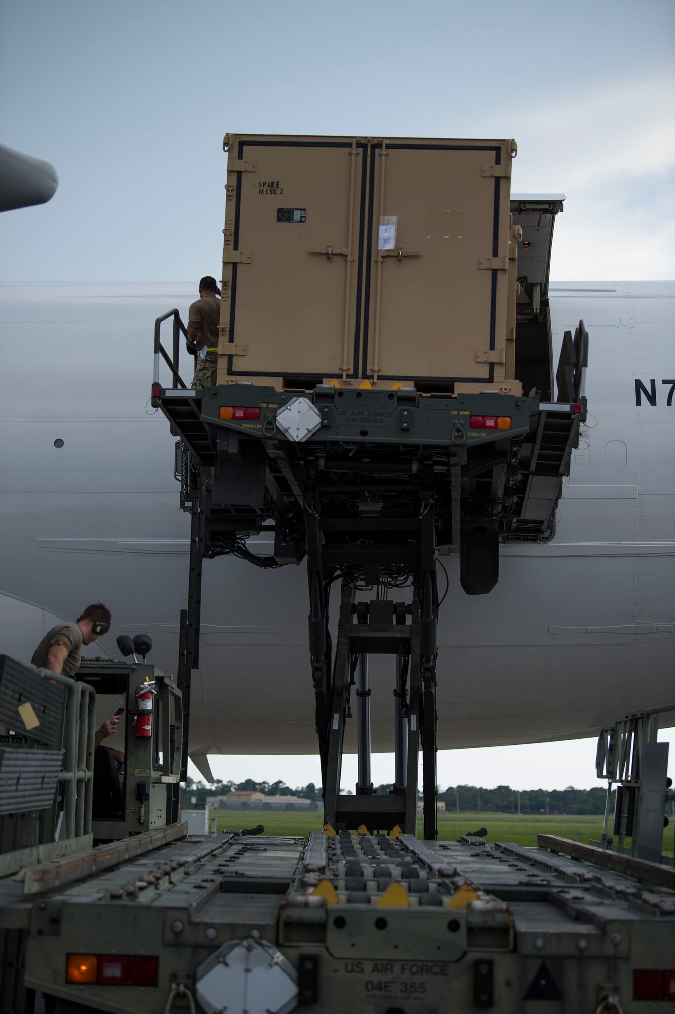 Members of the 6th Logistics Readiness Squadron (LRS) remove cargo from a Boeing 747 aircraft during a cargo movement at MacDill Air Force Base, Fla., July 31, 2019. With 32 increments of cargo weighing 144,470 pounds, this movement equates to 22 percent of total tonnage moved by the 6th LRS in 2019. (U.S. Air Force photo by Senior Airman Adam R. Shanks)