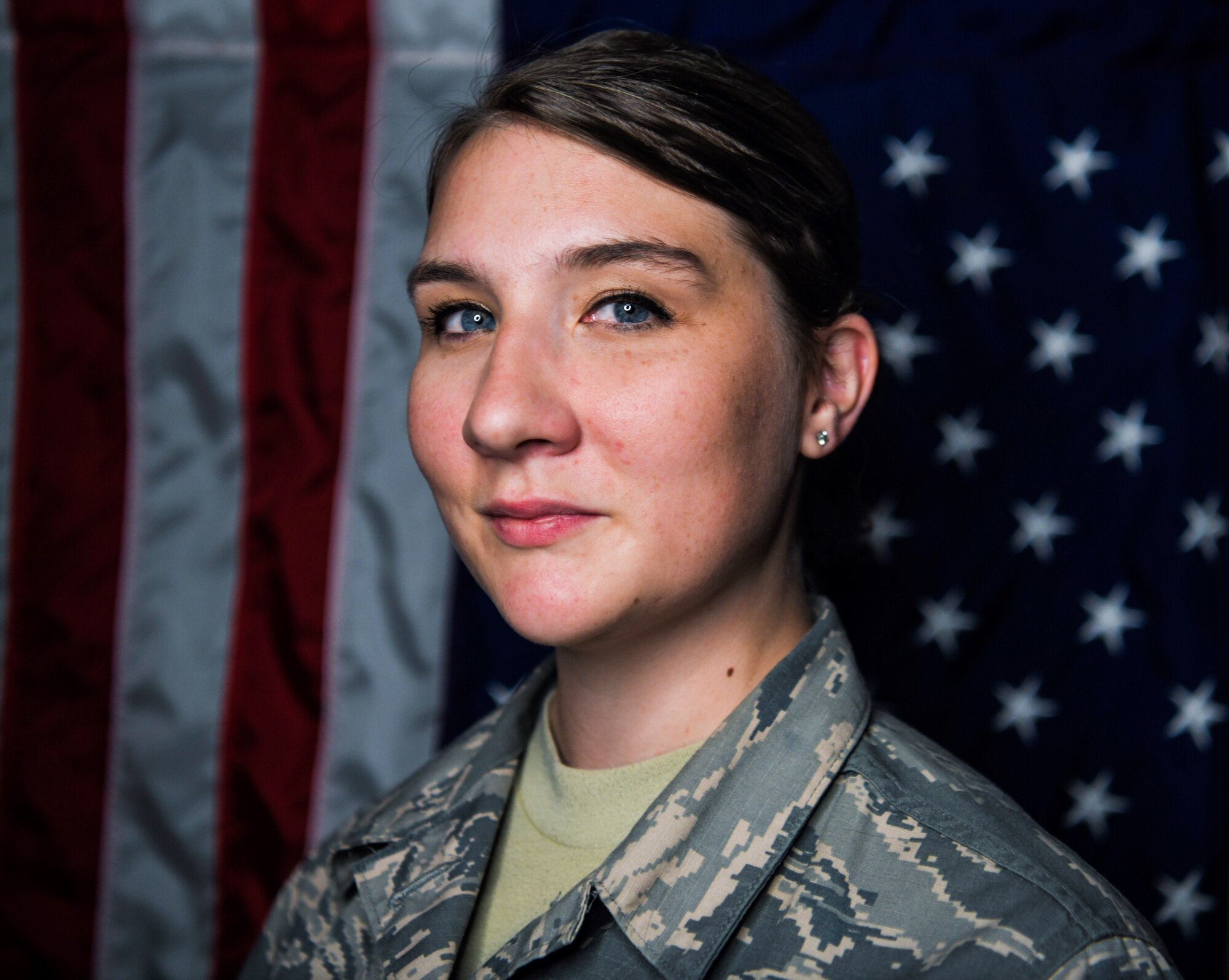 Airman 1st Class Whitney Hagood, 460th Force Support Squadron customer service technician, stands in front of the American flag, Sept. 10, 2019, on Buckley Air Force Base, Colo. Like herself, Hagood believes younger generations are still joining today because of the events of Sept. 11.