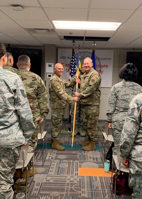 Col. John Gillespie, right, receives the guidon from Brig. Gen. Richard Kemble, 94th Airlift Wing commander, during an assumption of command ceremony Sept. 7, 2019. Gillespie assumed command of the 94th Aeromedical Staging Squadron. (Courtesy photo/Capt. Anna Sanchez)
