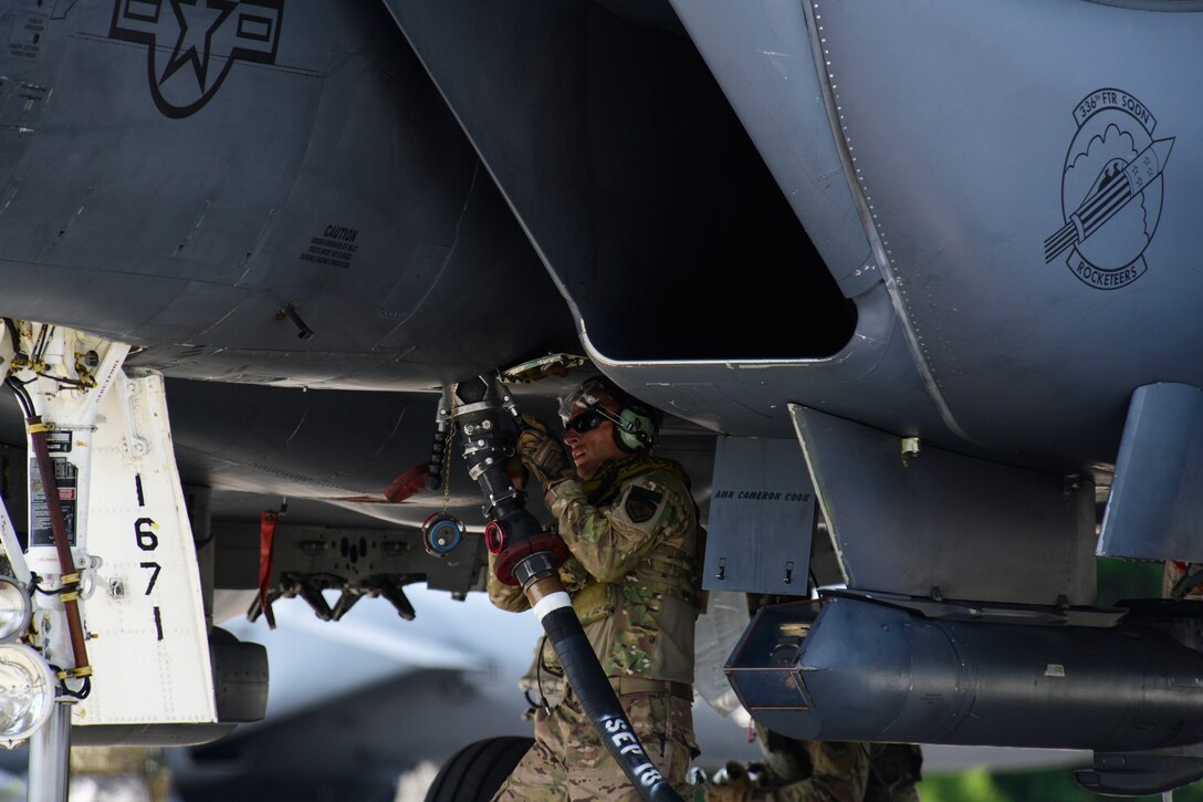 Tech. Sgt. Brandt Giambatista, 336th Aircraft Maintenance Unit electrical and environmental non-commissioned officer in charge, executes a hot-pit refuel on an F-15E Strike Eagle during the Combat Support Wing capstone, May 9, 2019, at Kinston Regional Jetport, North Carolina. After weeks of training on refueling, aircraft maintenance, security and more, 110 Airmen from 15 different bases separated into three different groups to put their newly found skills to the test. (U.S. Air Force photo by Senior Airman Kenneth Boyton)