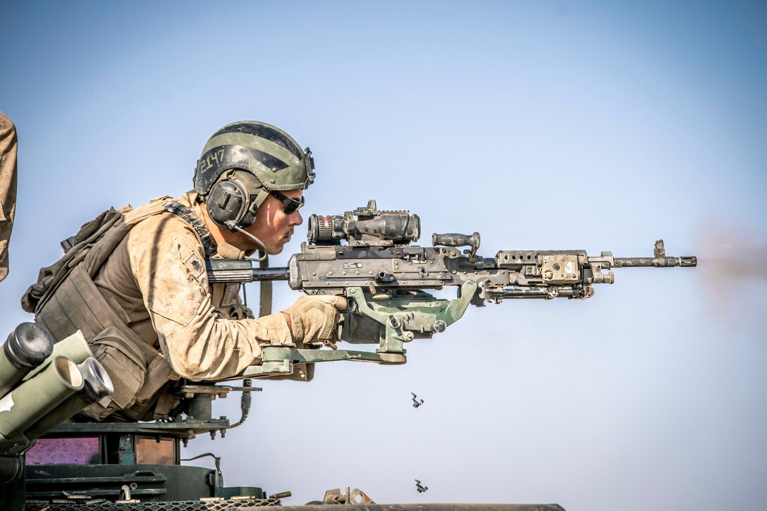 A Marine fires a machine gun.