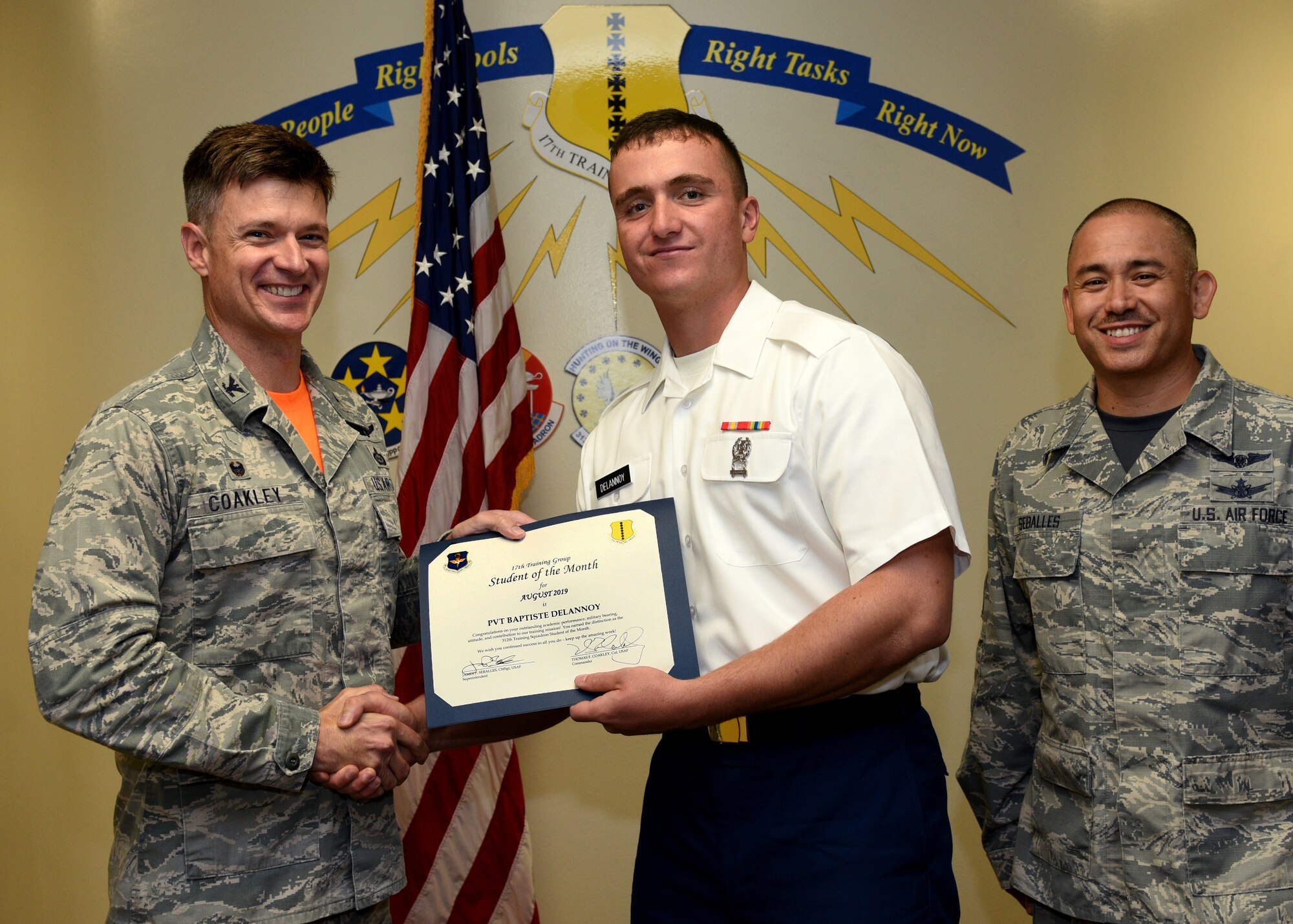 U.S. Air Force Col. Thomas Coakley, 17th Training Group commander, presents the 312th Training Squadron Student of the Month award to U.S. Army Pvt. Baptiste Delannoy, 312th TRS student, at Brandenburg Hall on Goodfellow Air Force Base, Texas, September 6, 2019. The 312th TRS’s mission is to provide Department of Defense and international customers with mission ready fire protection and special instruments graduates and provide mission support for the Air Force Technical Applications Center. (U.S. Air Force photo by Airman 1st Class Robyn Hunsinger/Released)