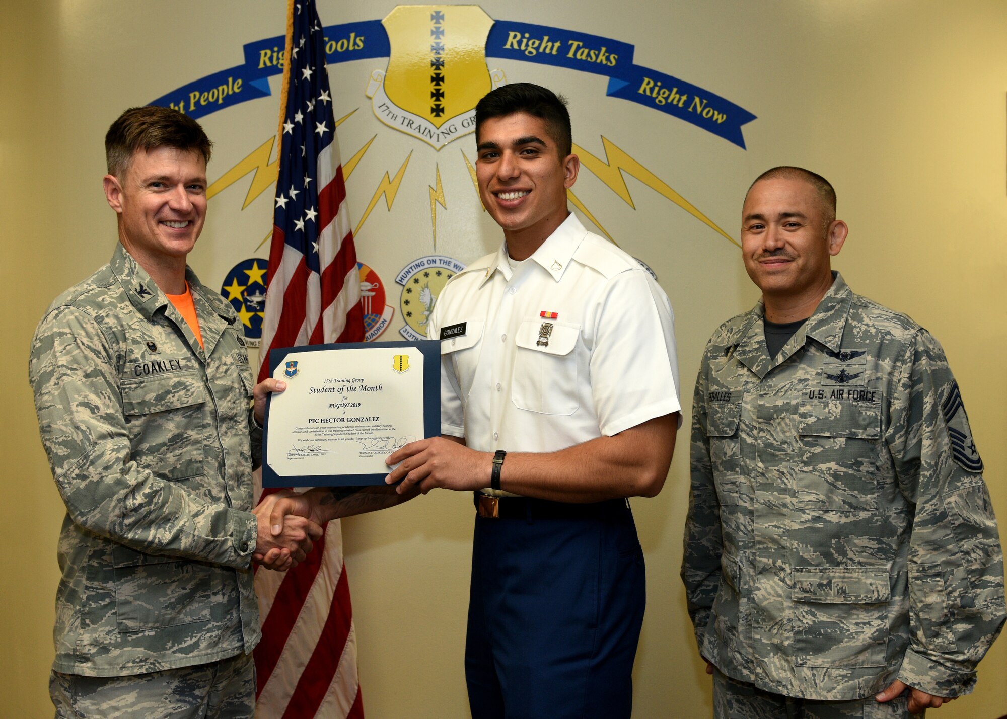 U.S. Air Force Col. Thomas Coakley, 17th Training Group commander, presents the 316th Training Squadron Student of the Month award to U.S. Army Pfc. Hector Gonzalez, 316th TRS student, at Brandenburg Hall on Goodfellow Air Force Base, Texas, September 6, 2019. The 316th TRS’s mission is to conduct U.S. Air Force, U.S. Army, U.S. Marine Corps, U.S. Navy and U.S. Coast Guard cryptologic, human intelligence and military training. (U.S. Air Force photo by Airman 1st Class Robyn Hunsinger/Released)