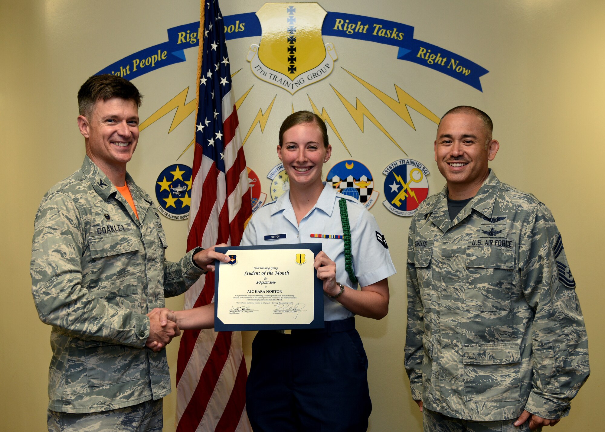 U.S. Air Force Col. Thomas Coakley, 17th Training Group commander, presents the 315th Training Squadron Student of the Month award to Airman 1st Class Kara Norton, 315th TRS student, at Brandenburg Hall on Goodfellow Air Force Base, Texas, September 6, 2019. The 315th TRS’s vision is to develop combat-ready intelligence, surveillance and reconnaissance professionals and promote an innovative squadron culture and identity unmatched across the U.S. Air Force. (U.S. Air Force photo by Airman 1st Class Robyn Hunsinger/Released)
